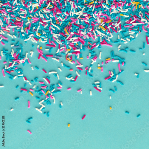 Colorful sprinkles on a blue background, top view with copy space photo