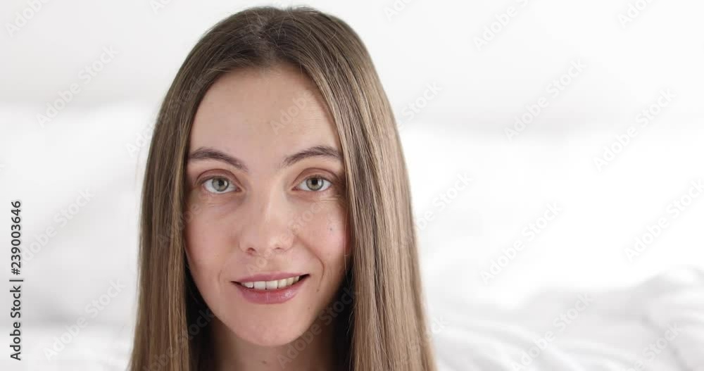 Closeup crop beautiful face of young positive lady looking at camera on blurred background Closeup crop beautiful face of young positive lady looking at camera on blurred background