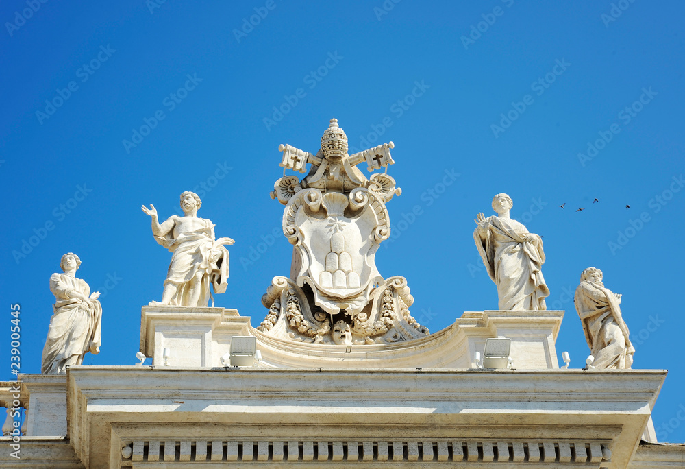 Obraz premium Detail from baroque Saint Peter's colonnade with beautiful statues of saints and Pope Alexander VII coat of arms. Vatican City (Rome, Italy)