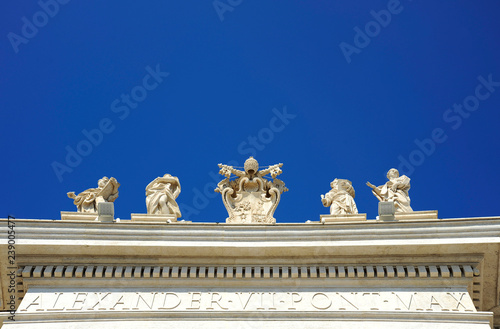 Detail from baroque Saint Peter's colonnade with beautiful statues of saints and Pope Alexander VII coat of arms. Vatican City (Rome, Italy) photo