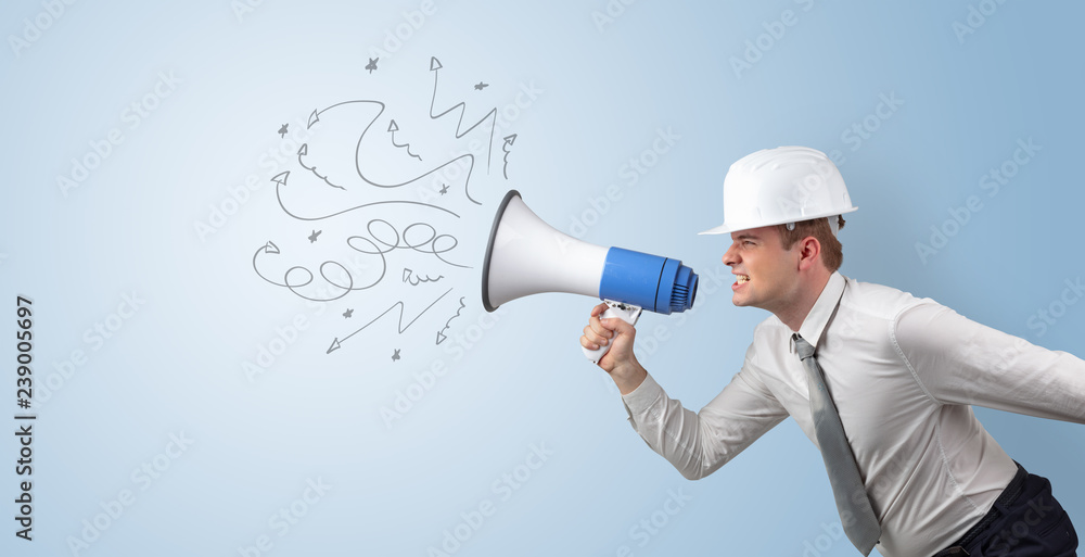 Fototapeta premium Young architect constructor yelling with megaphone and copyspace 