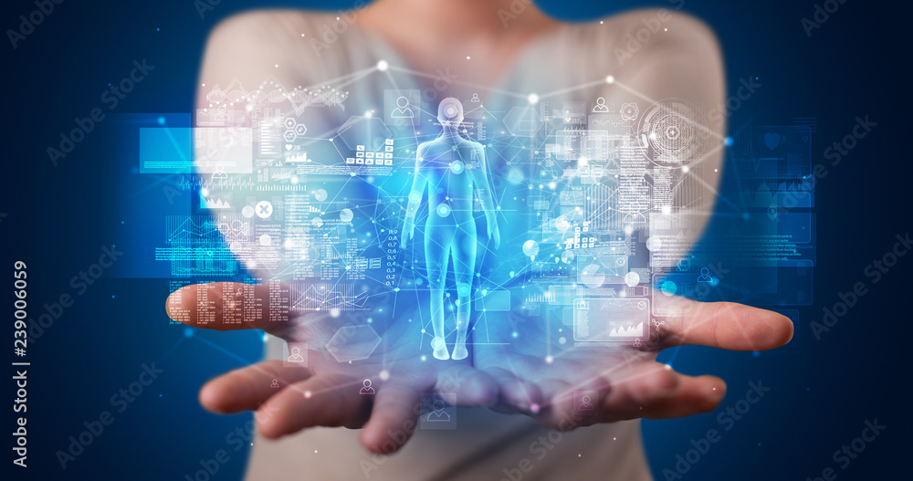 Young person holding hologram projection displaying health related graphs and symbols
Young person holding hologram projection displaying health related graphs and symbols