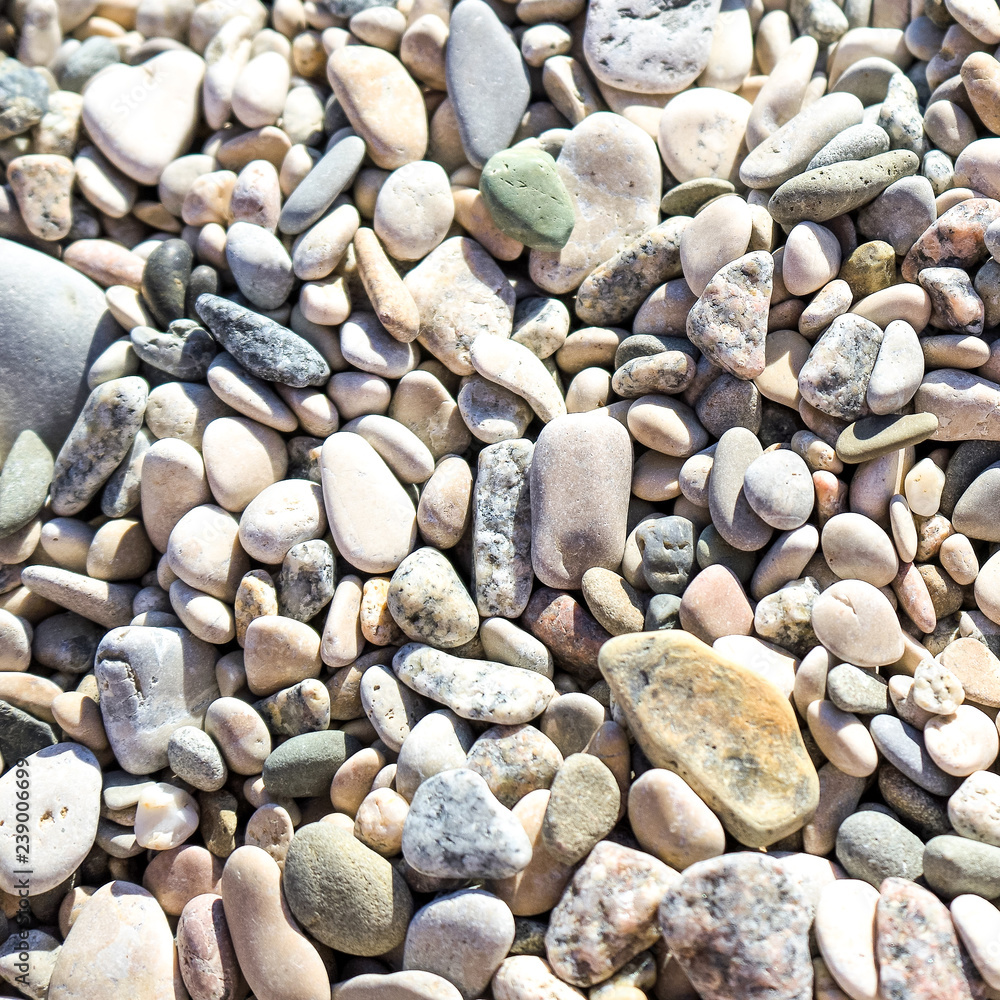 pebblesPebble stones of different colors and shapes background. pebblesPebble stones of different colors and shapes background.