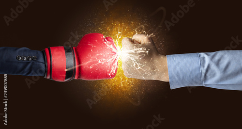 Two hands fighting with orange dust, spark, glow and smoke concept   © ra2 studio