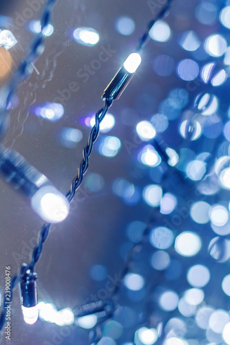Christmas lights with blurred background. New Year glowing garland with bokeh