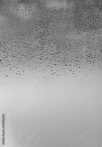 Принти на полотні Natural drops of rain on the glass, the view on the street is blurred