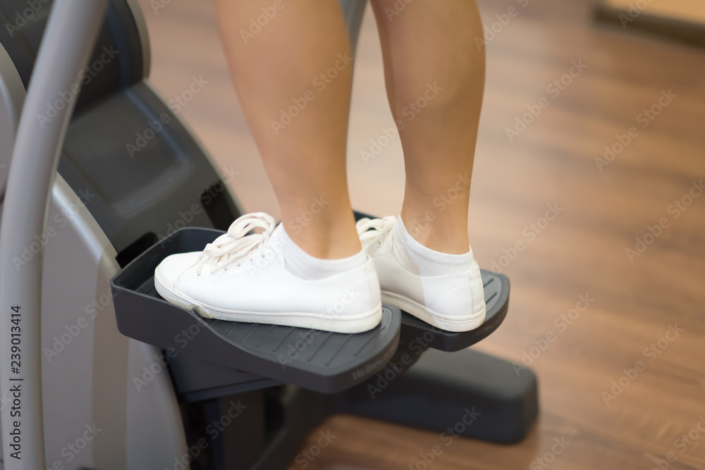Girl working on the stepper in the gym Girl working on the stepper in the gym