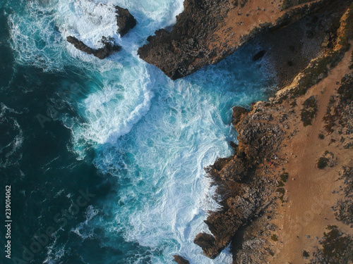Aerial view of waves crashing against the coastline. Seascape panorama taking with a Drone.