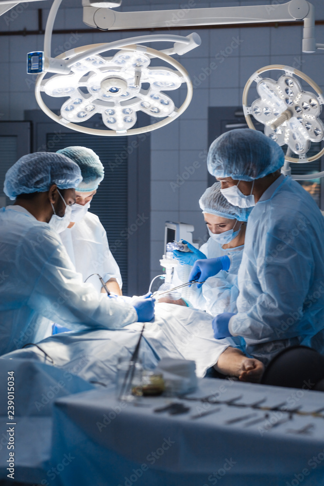 Stitching after a complex and bloody surgery. Modern medical equipment