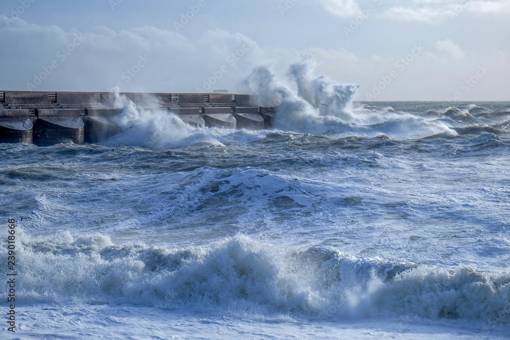rough seas crashing against Brighton marina habour wall,