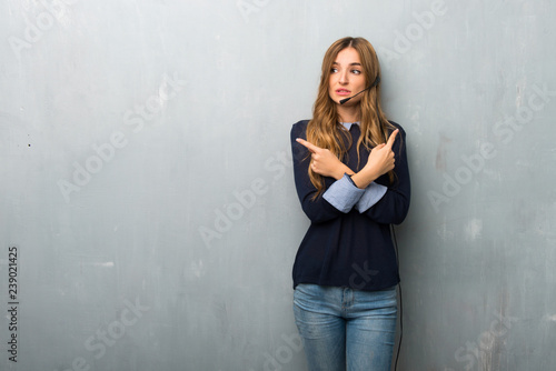Telemarketer woman pointing to the laterals having doubts
