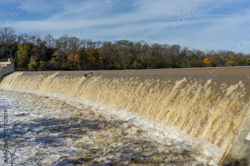 rural landscape with river dam after rain