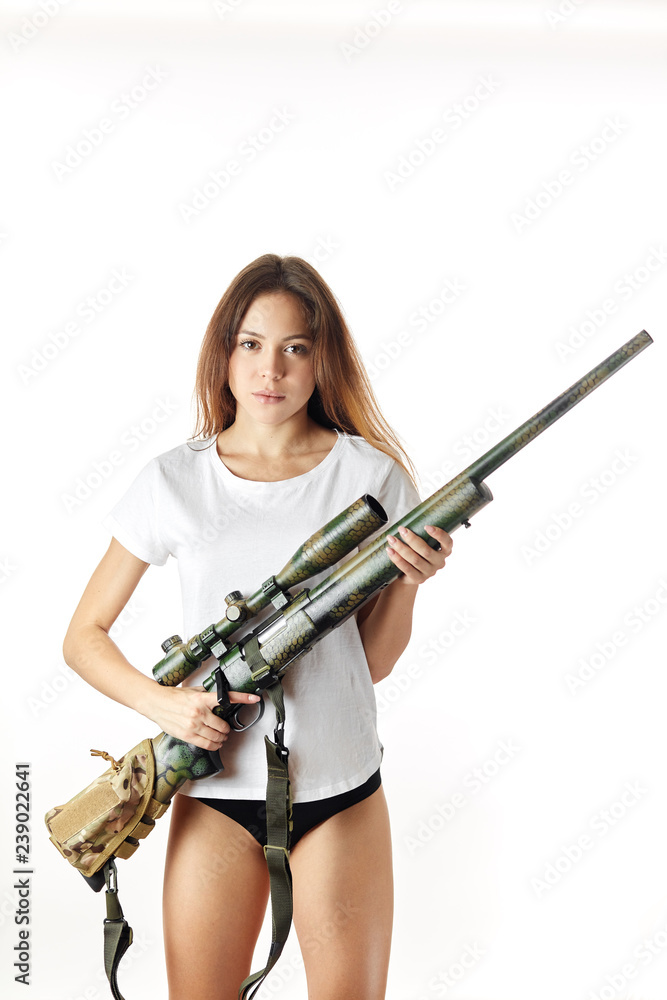confident serious woman holding a gun and looking at the camera. isolated white background. studio shot.killer, murder, crime,entertainment, revenge.