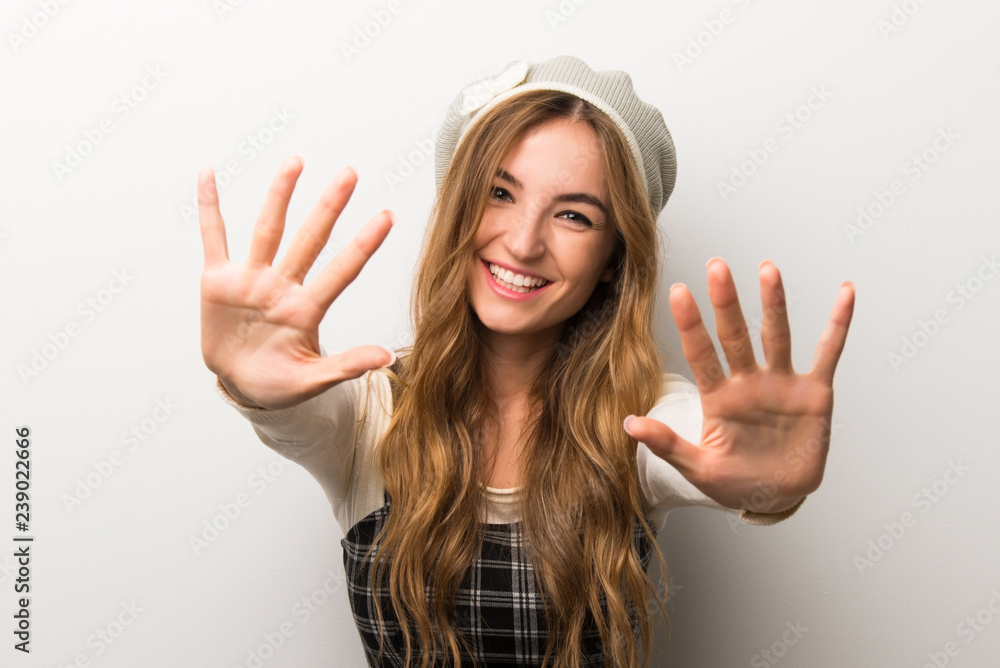 Fashionably woman wearing hat counting ten with fingers Fashionably woman wearing hat counting ten with fingers