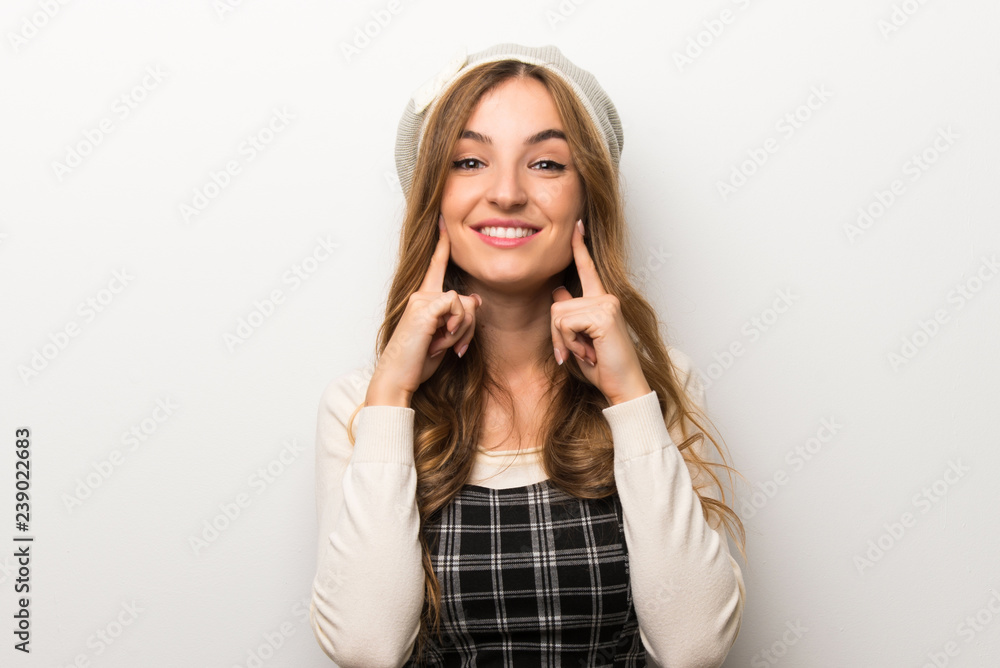 Fashionably woman wearing hat smiling with a happy and pleasant expression Fashionably woman wearing hat smiling with a happy and pleasant expression