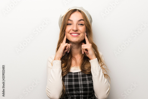 Fashionably woman wearing hat smiling with a happy and pleasant expression