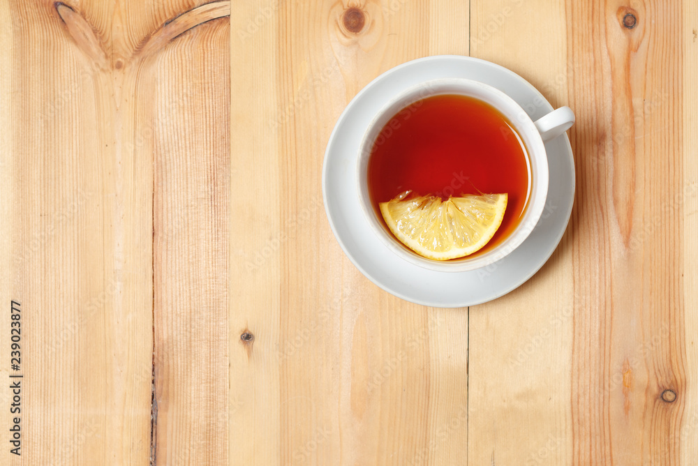 tea with lemon in white Cup on wooden surface background tea with lemon in white Cup on wooden surface background