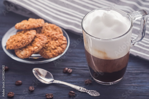  Coffee latte on wooden table. Toned photo