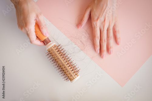 hair fall and lost alopecia woman problem on the comb.