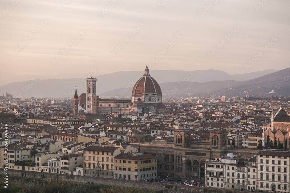 Landscape of the city of Florence, Italy on a long-focus lens, view from the viewpoint of the cathedral Cattedrale di Santa Maria del Fiore in the evening time of the sunset.