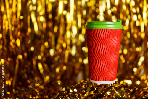 Coffee to go in red cup and Christmas golden metafan photo