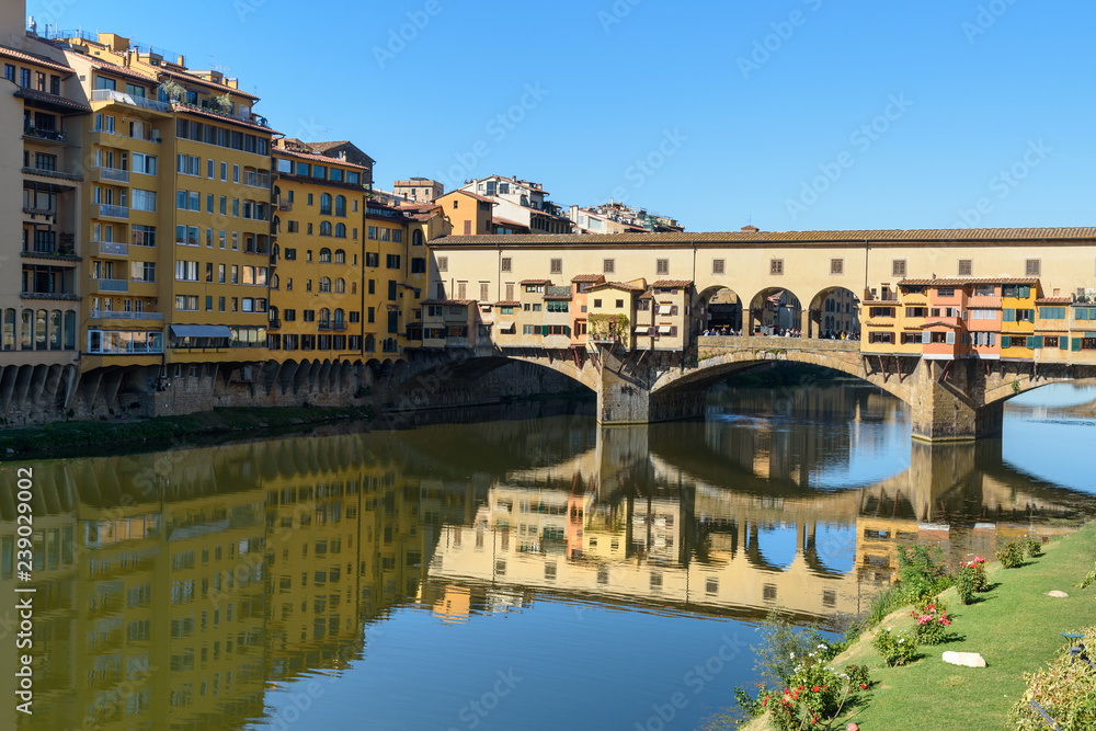 Ponte Vecchio Bridge over river Arno at sunny day. Florence. Italy