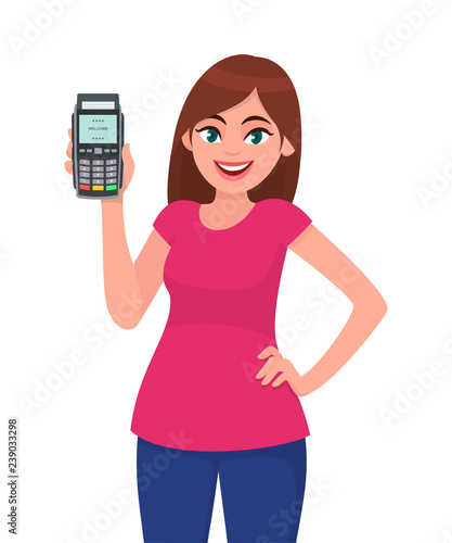 Young woman showing/holding pos payment terminal or credit/debit cards swiping machine while holding hand on hip. Wireless modern bank payment, business and finance concept illustration in vector.