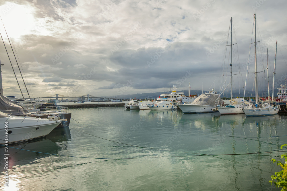 Philippines Mactan Island Yacht marina on a cloudy day in a tranquil scene with reflections in water