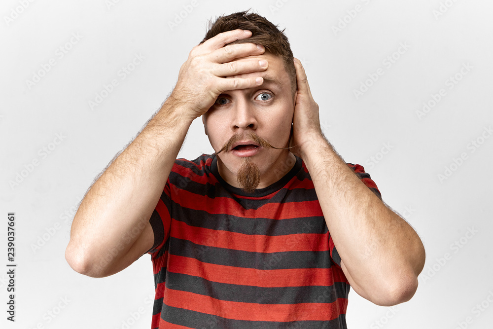 Stop it, this is blowing my mind! Desperate stressed young bearded male being exhausted, having fight with his wife, holding hand on his forehead. Stylish guy looking at camera with panic and anxiety Stop it, this is blowing my mind! Desperate stressed young bearded male being exhausted, having fight with his wife, holding hand on his forehead. Stylish guy looking at camera with panic and anxiety