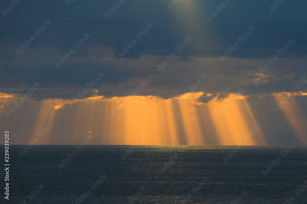 Fototapeta premium Sun rays are shining through the clouds