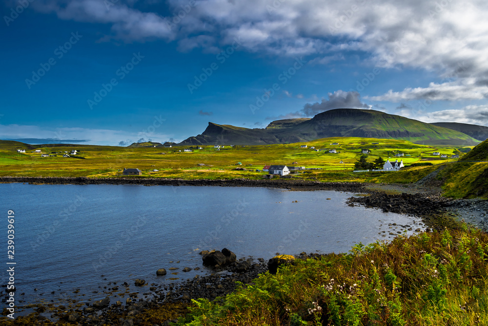 Obraz premium Scenic Village In Rural Landscape At The Coast Of The Isle Of Skye In Scotland