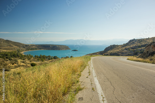 curved empty car road in mountain sea landscape