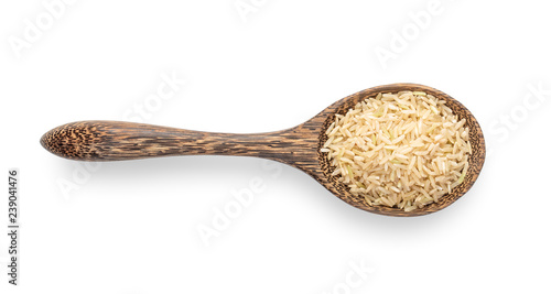 brown rice in wood spoon isolated on white background. top view