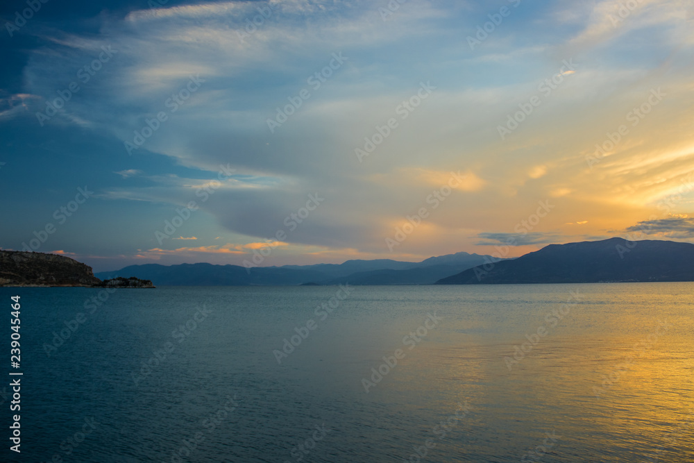 soft focus romantic nature scenery landscape of sea bay calm water surface surrounded by mountain horizon background in twilight evening sunset time wallpaper pattern with empty space for copy or text