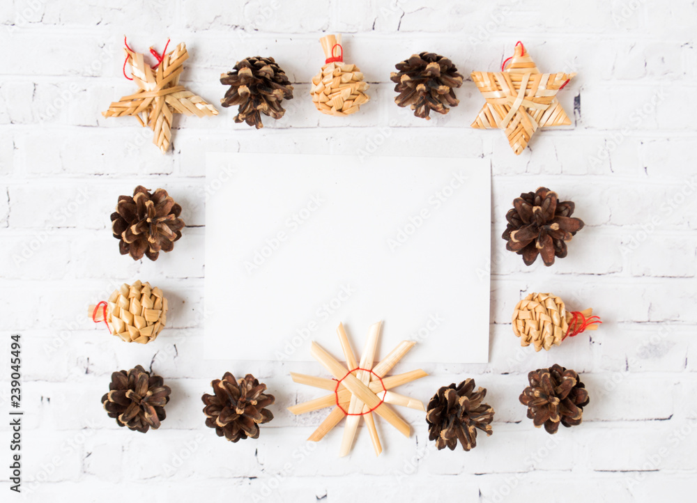 Festive Christmas frame of cones and straw toys Festive Christmas frame of cones and straw toys
