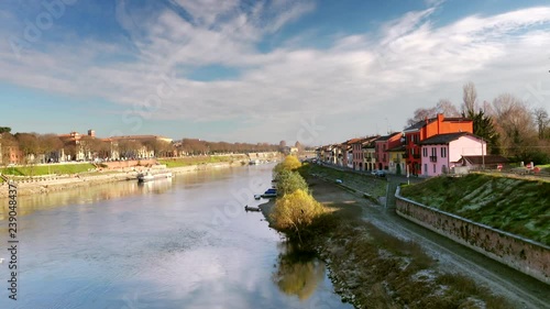 flowing waters of the Ticino river near colorful houses in Pavia in Italy
