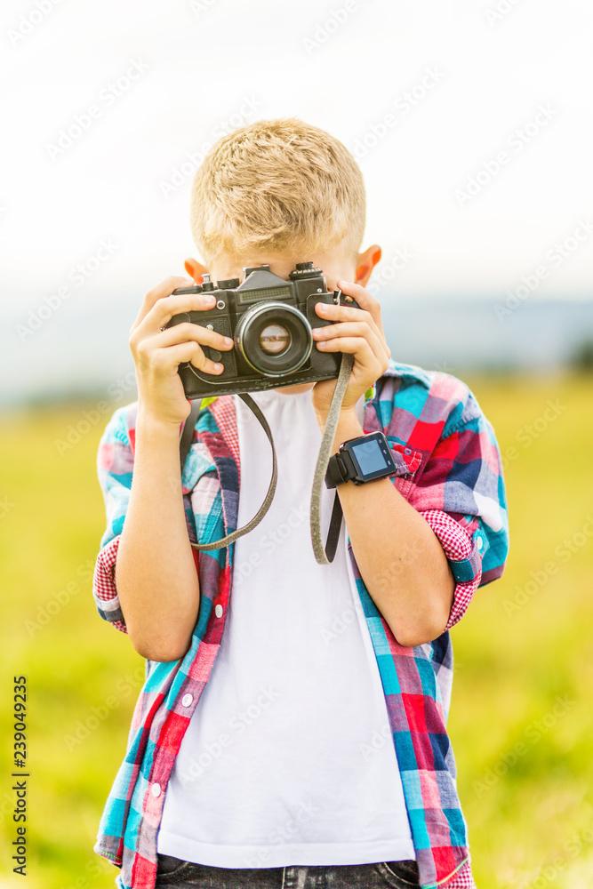Young blonde boy holding a camera Young blonde boy holding a camera