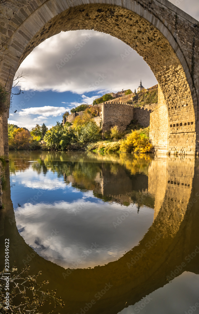 Fototapeta premium The Puente de Alcantara, a Roman arch bridge in Toledo, Catile-La Mancha, Spain, spanning the Tagus River. The word comes from Arabic bridge