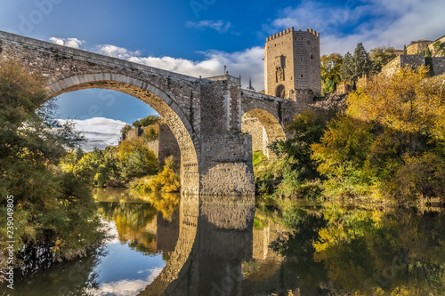 The Puente de Alcantara, a Roman arch bridge in Toledo, Catile-La Mancha, Spain, spanning the Tagus River. The word comes from Arabic bridge