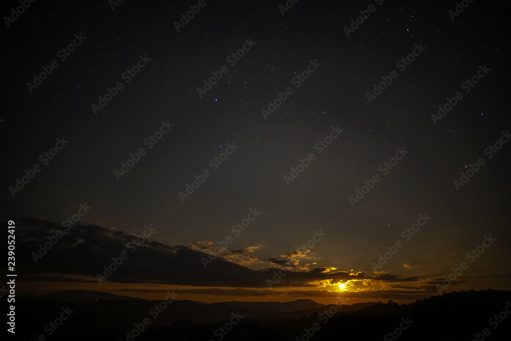 The moon is rising in the sky with stars. The moon is rising in the sky with stars.