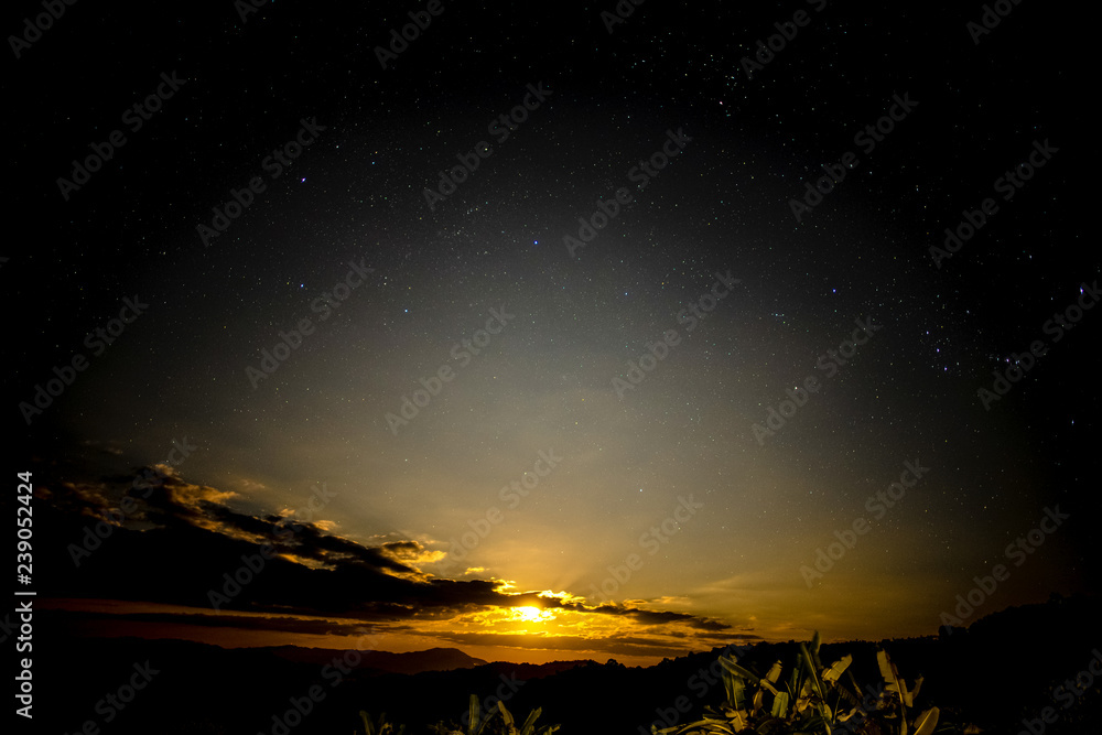 The moon is rising in the sky with stars. The moon is rising in the sky with stars.