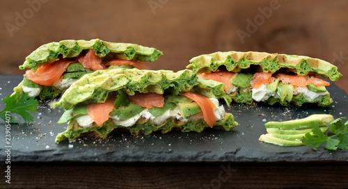 Spinatwaffeln mit geraeucherter Lachsforelle Avcado und Meerettichcreme auf-Schiefer photo