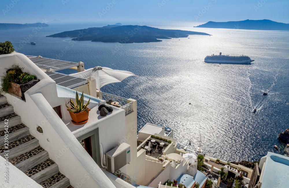 A beautiful view over the sea and the island of Santorini in Greece. Holiday and travel concept.