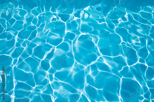 background blue transparent water of swimming pool, vibrating with ripples