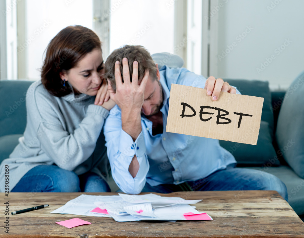 © SB Arts Media - Desperate young Couple showing debt sign having financial problems feeling stressed paying bills © SB Arts Media - Desperate young Couple showing debt sign having financial problems feeling stressed paying bills