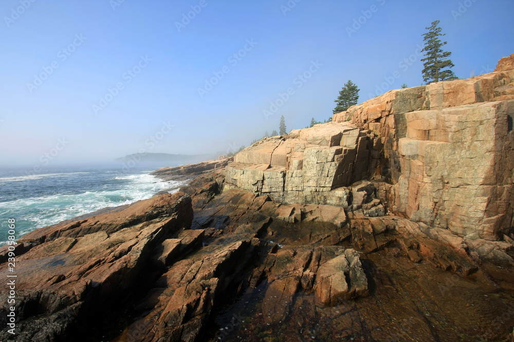 The rugged coast of Acadia National Park, Maine, on a sunny summer morning after the lifting of much of the early morning fog.