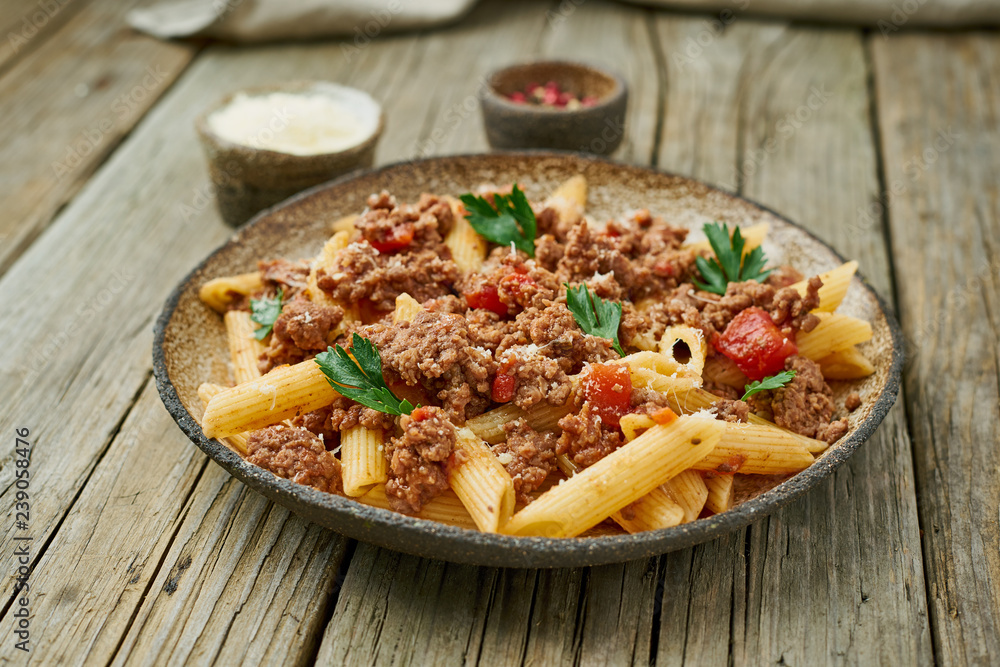 Bolognese pasta. Fusilli with tomato sauce, ground minced beef. Traditional italian cuisine. Side view. Bolognese pasta. Fusilli with tomato sauce, ground minced beef. Traditional italian cuisine. Side view.