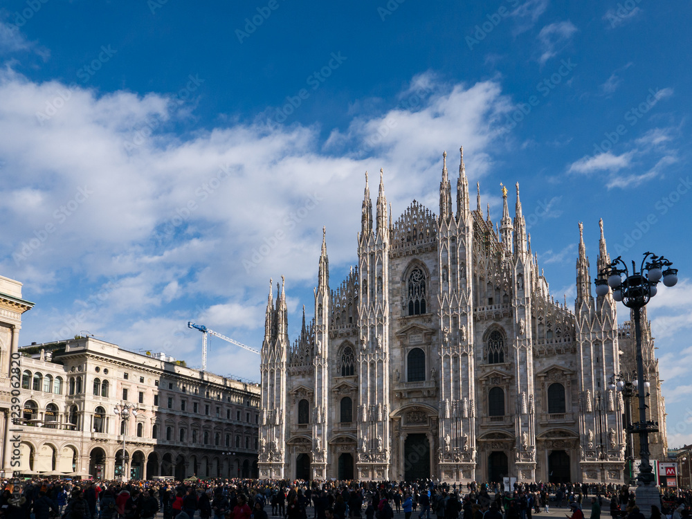 tourists stroll in Piazza Duomo and go shopping for Christmas.