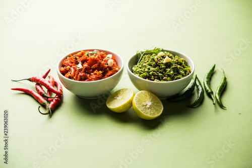 Hot and spicy Hot green and red chilli chutney using lal and hari mirch, cumin seeds, lemon juice and coriander. served in a bowl. selective focus photo