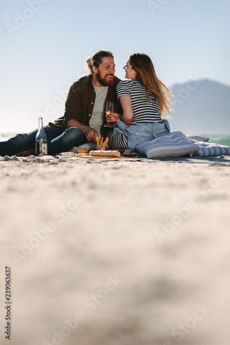 Beautiful couple enjoying picnic day on the beach